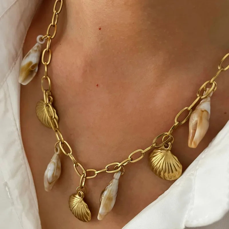 Bohemian style gold chain necklace with seashell charms.