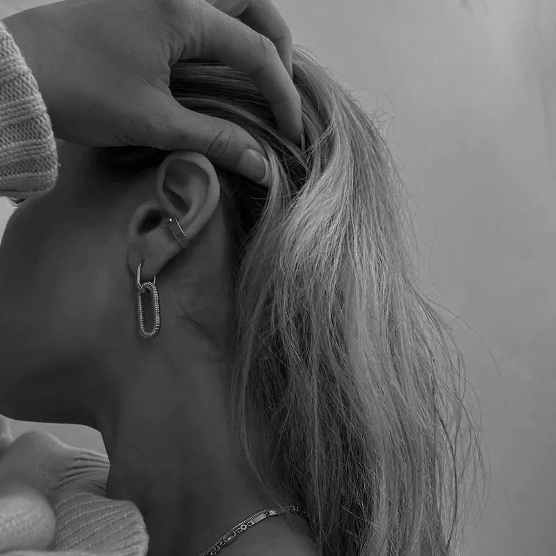 Close-up of a person wearing an earring in a black white background