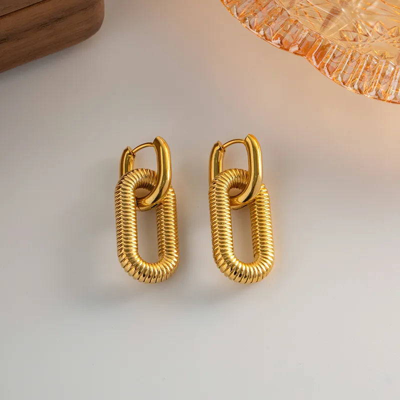 Pair of gold hoop earrings on a light background
