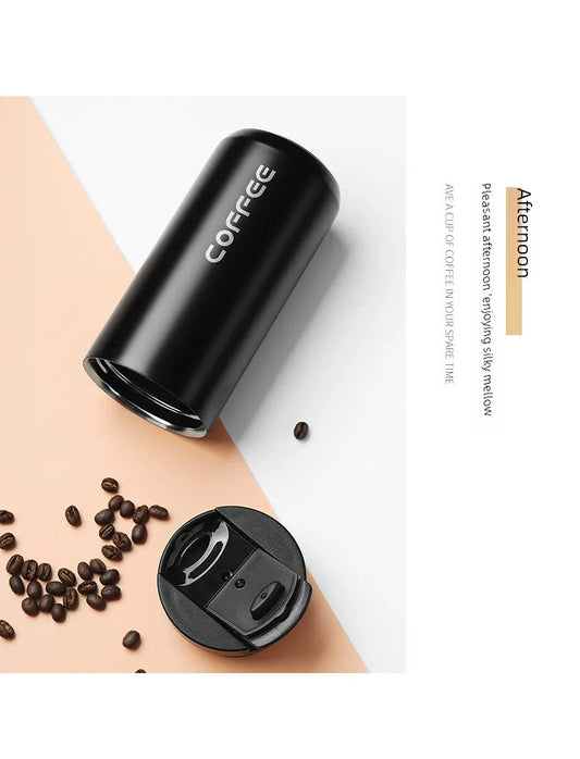 Black coffee container with 'COFFEE' text on a beige surface with scattered coffee beans.